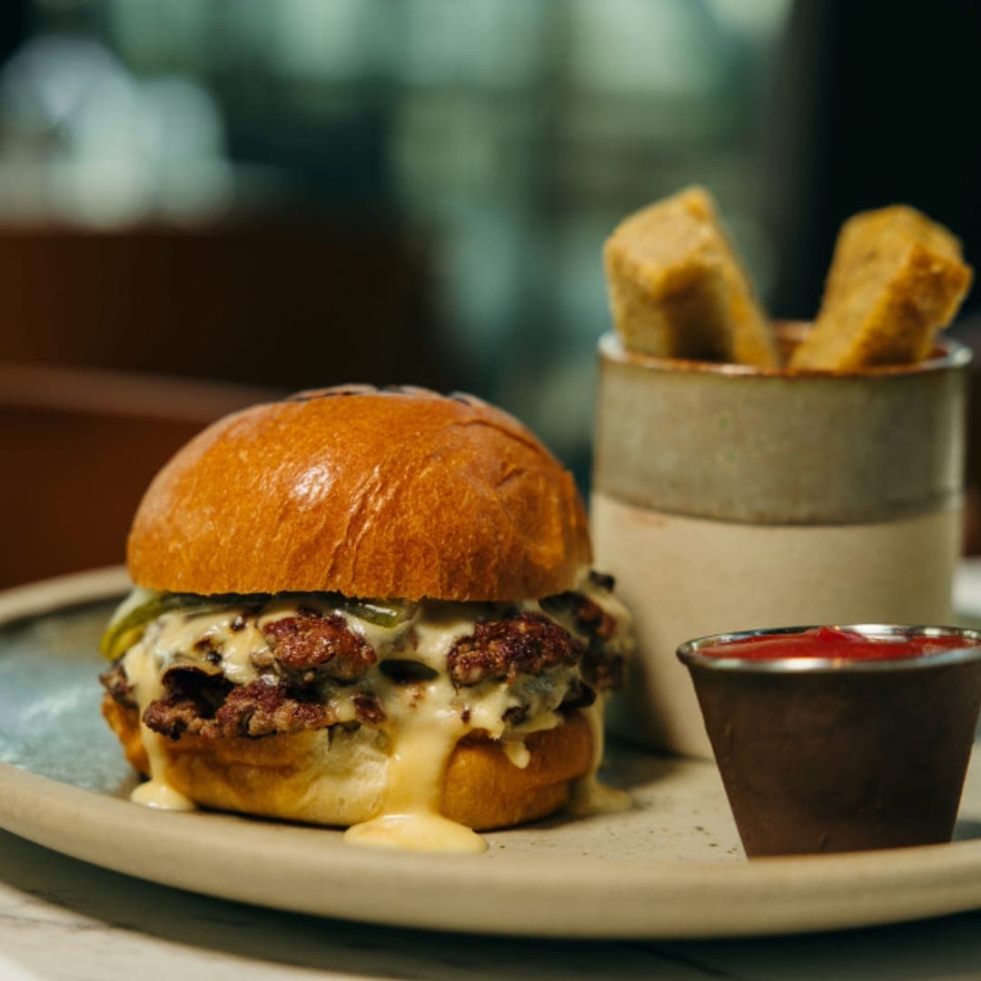 crowdedhouse-gallery-02 CrowdedHouse cheeseburger with smash patty, cheese sauce and chunky fries on a ceramic plate
