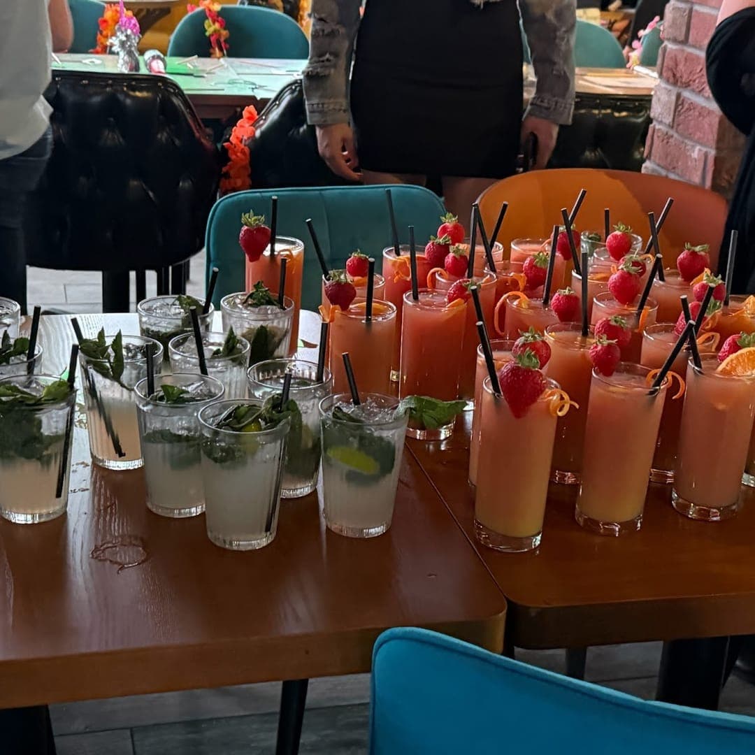 tapas-bar-by-olive-branch-cocktails-strawberry-mojito Selection of cocktails at TAPAS BAR by olive branch including mojitos with fresh mint and pink strawberry garnished drinks ready to serve