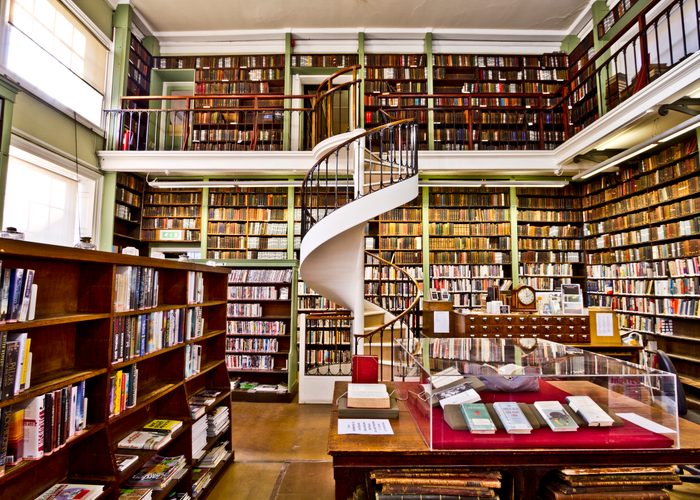 Interior of The Leeds Library showing two floors of gallery shelving and the Greek Revival reading room